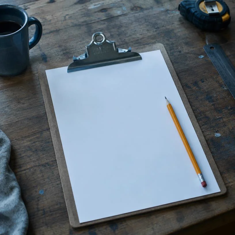 Clipboard with a blank estimate sheet and pencil